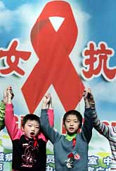 Kinesiska barn under världs-aidsdagen. Barnen har förlorat någon förälder i aids. Rosetten är en symbol för sjukdomen aids. Foto: Pressens Bild