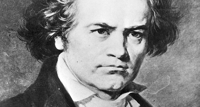 En svartvit bild på Ludwig van Beethoven. Han ser sträng ut. med lätt rynkade ögonbryn och ganska rufsigt hår som hänger ner över öronen. Han har en vit skjorta med krås och en svart kavaj.