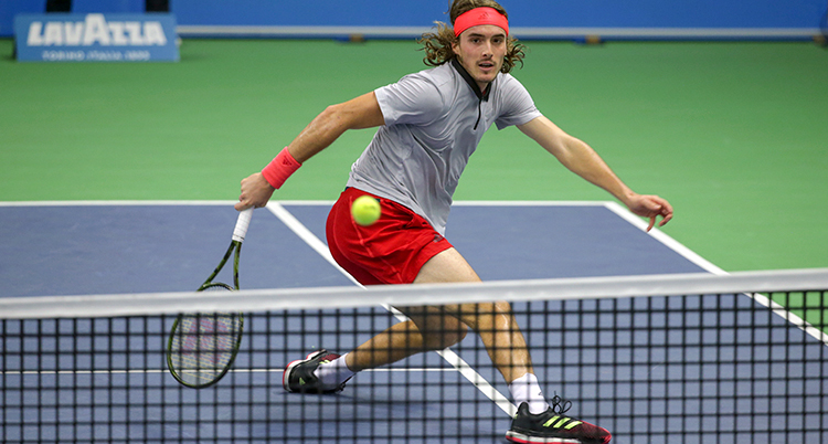 Stefano Tsitsipas framför tennisnätet.