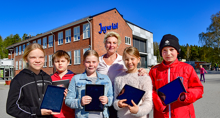 De står bredvid varandra. De håller i varsin läsplatta.