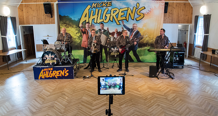 Micke Ahlgrens spelar. I förgrunden en mobilkamera som filmar.