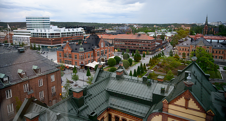En bild tagen ovanifrån över staden. Flera stora hus syns.