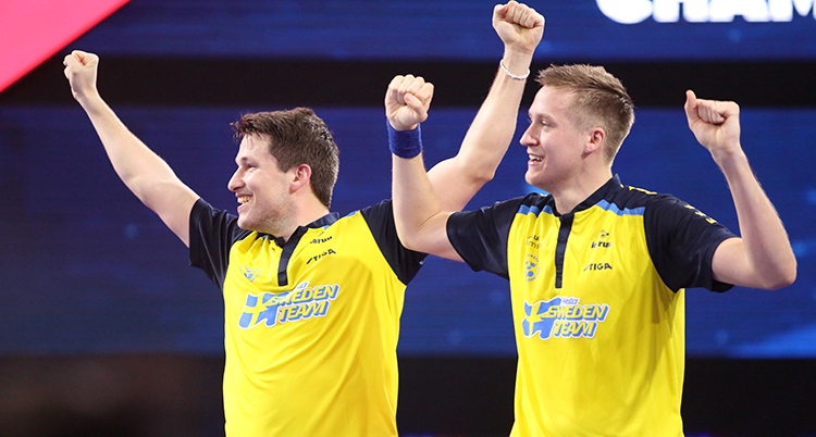 Bordtennisspelarna Mattias Falck och Kristian Karlsson firar sitt VM-guld.