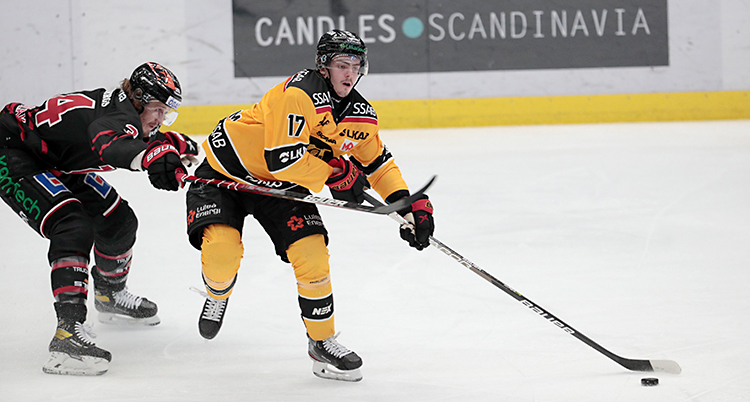Spelaren i Luleå har pucken. En spelare i Örebro försöker stoppa honom.