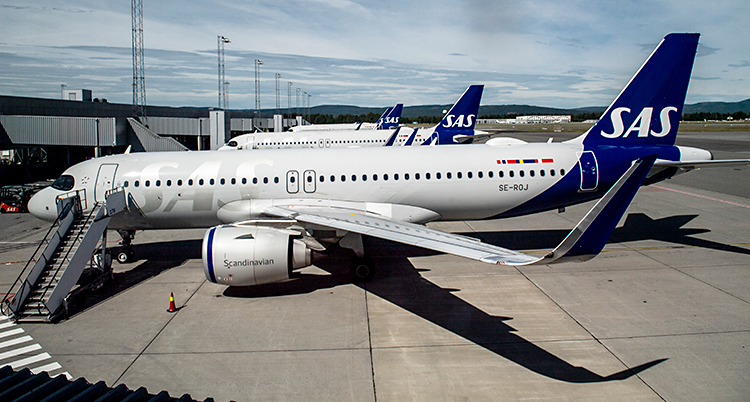 Flera flygplan står vid en flygplats.
