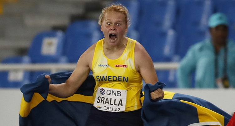 En glad friidrottstjej skriker ut sin glädje efter seger.