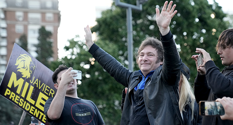 Milei vinkar och blir fotograferad.