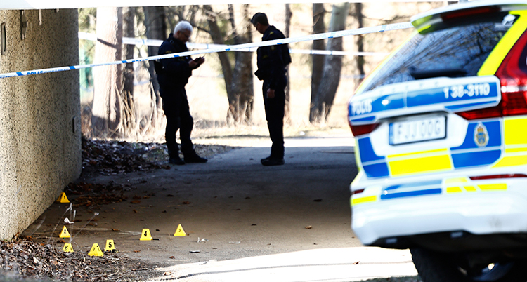 Poliser står utanför en gångtunnel och tittar mot marken. I förgrunden syns en polisbil och avspärrningsband.