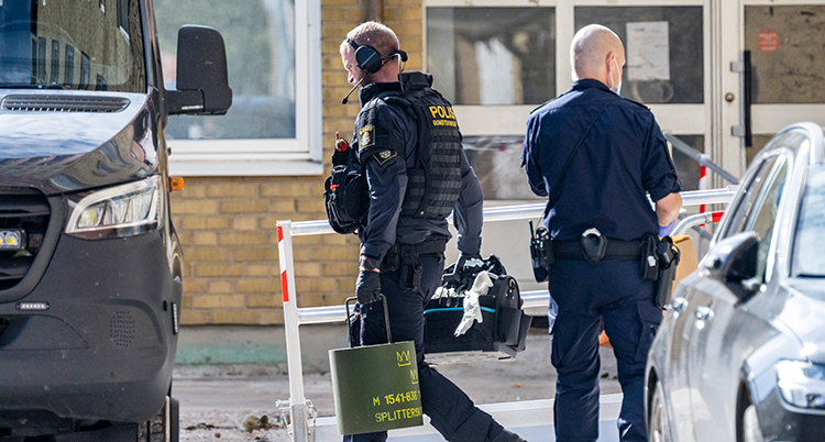 En polis bär en hink.